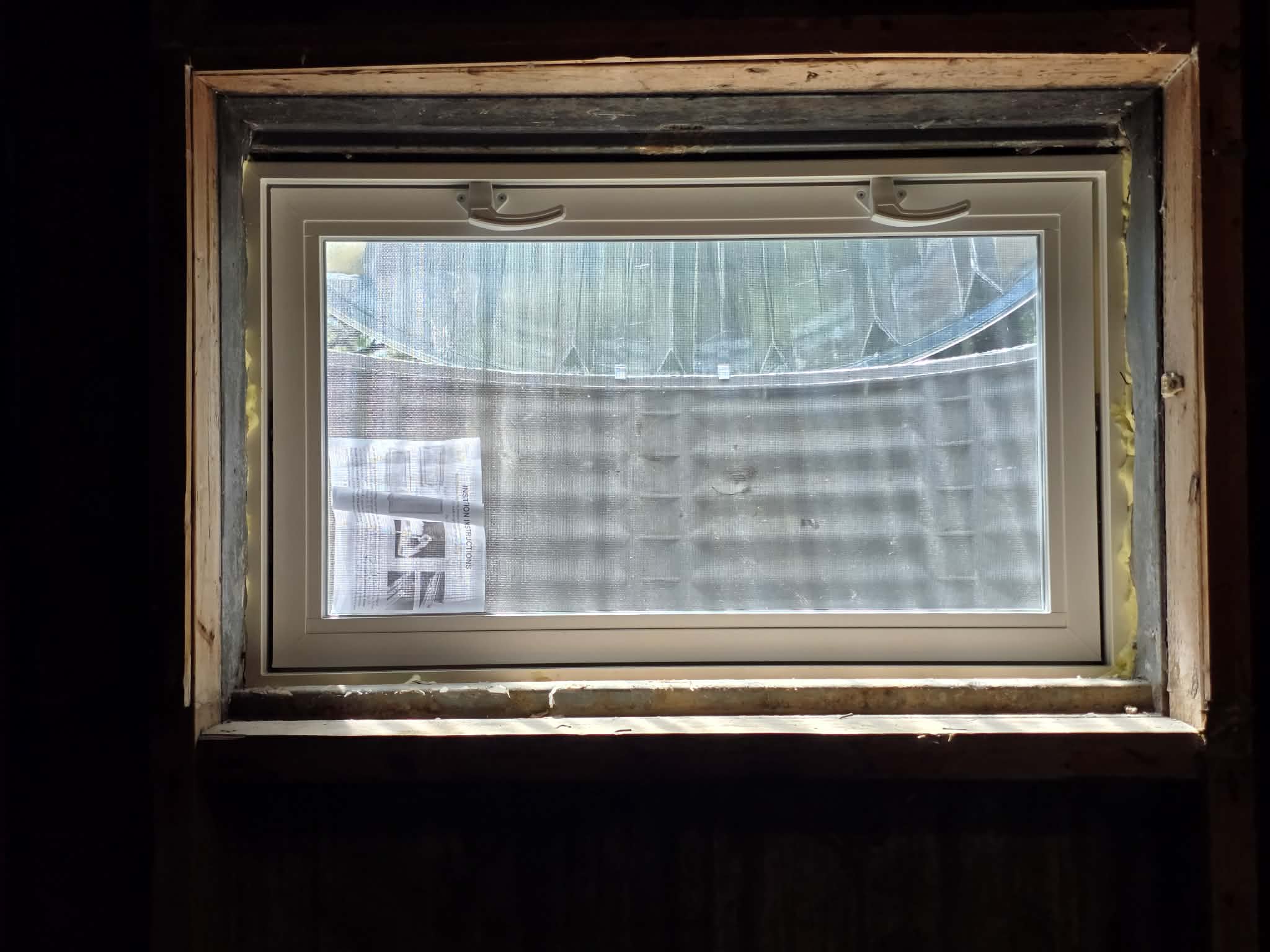 Window installations with wells, caps, and grading β photo 1