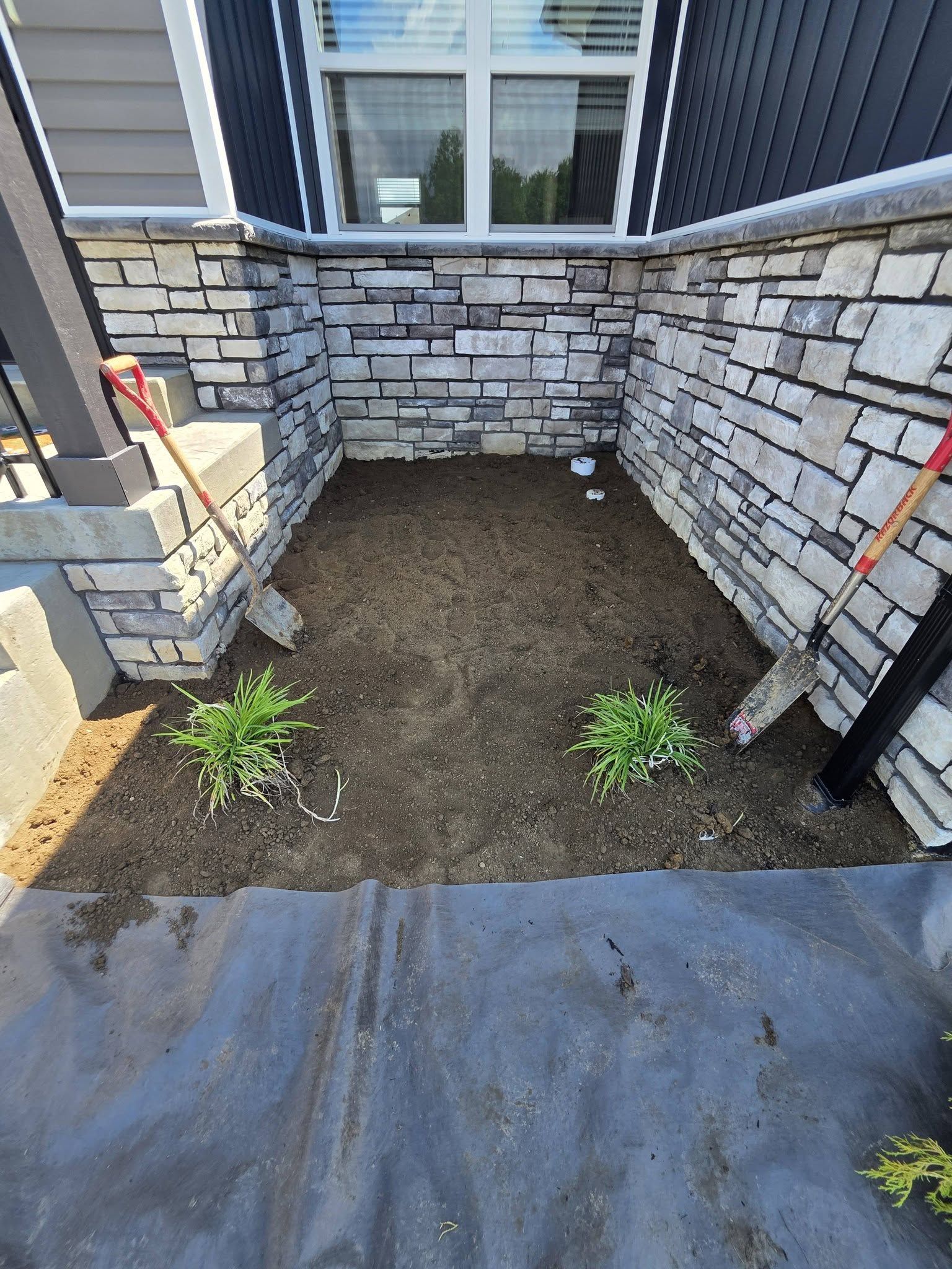 This Week's Work: 43' Curved Retaining Wall, French Drain & Grading — photo 1